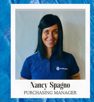 Nancy Spagno, purchasing manager, in a portrait against an ocean blue background.